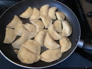 perogies in frying pan, cooking