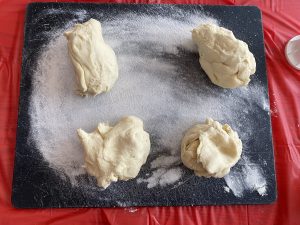 perogy dough separated into 4 wedges on cutting board