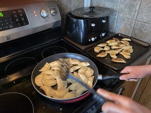 perogies being fried until golden brown on both sides