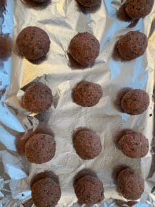 formed meatballs on baking sheet