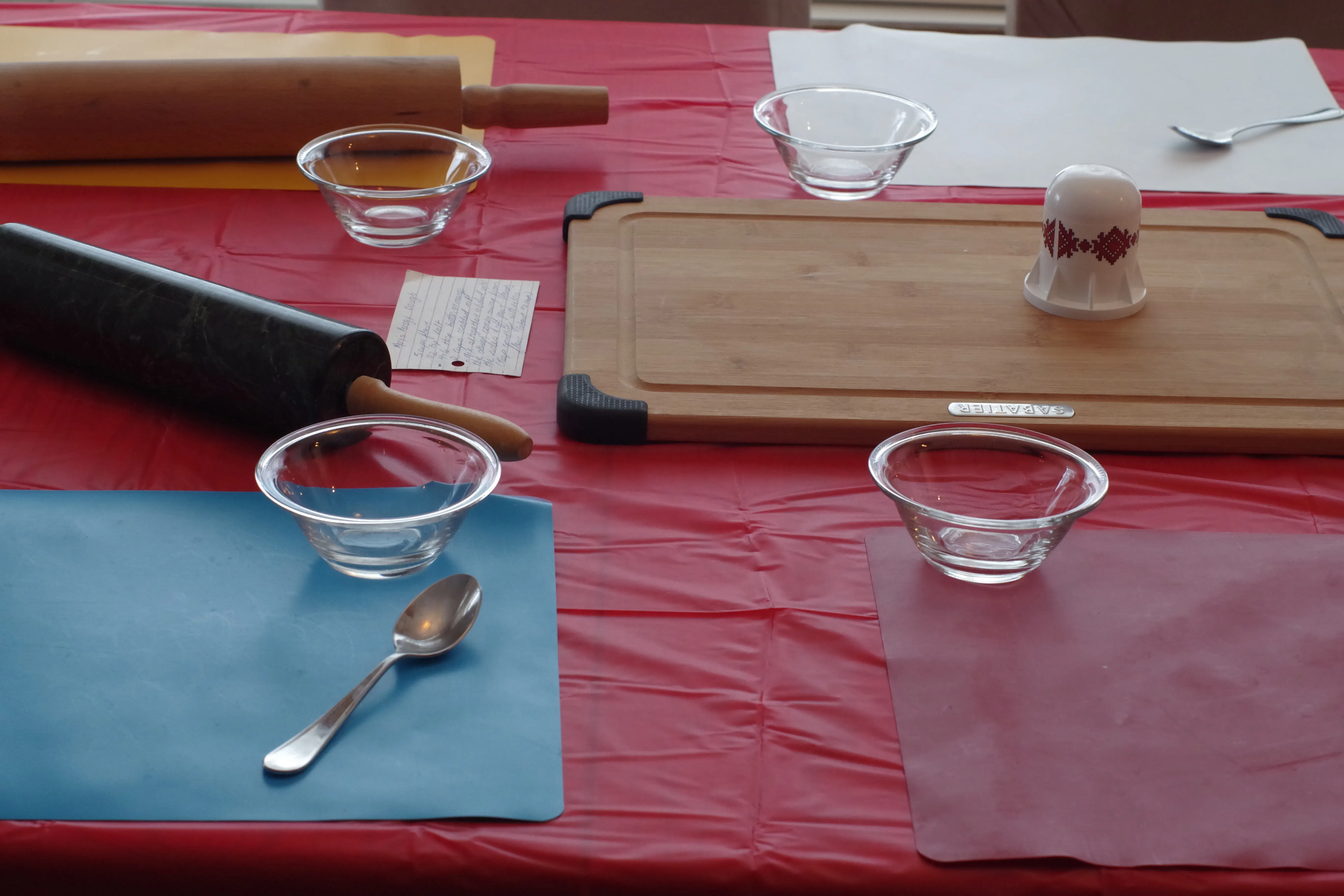 table set up for perogy party with cutting board, rolling pins etc..