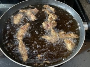 ginger beef being deep-fried
