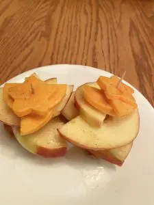 caramel apple cheddar bites on a white plate after being cut 24 hours ago