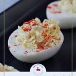 Pinterest pin with dark text on light grey background and photo deviled egg on black serving tray