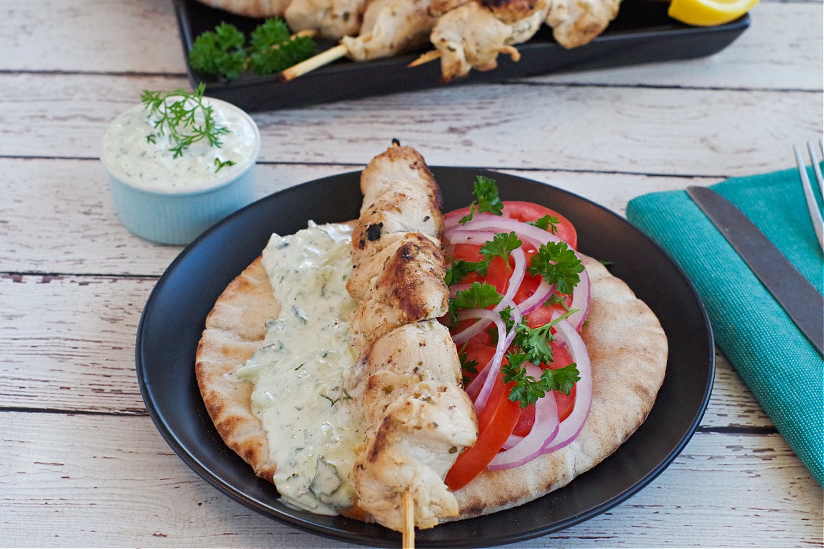 Greek Chicken Souvlaki on a pita with veggies and tzatziki sauce