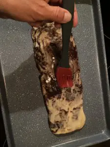 biscotti log being brushed with egg wash