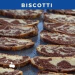 chocolate marble biscotti on a blue baking sheet