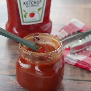 BBQ sauce with ketchup in a jar with a bottle of ketchup in the background