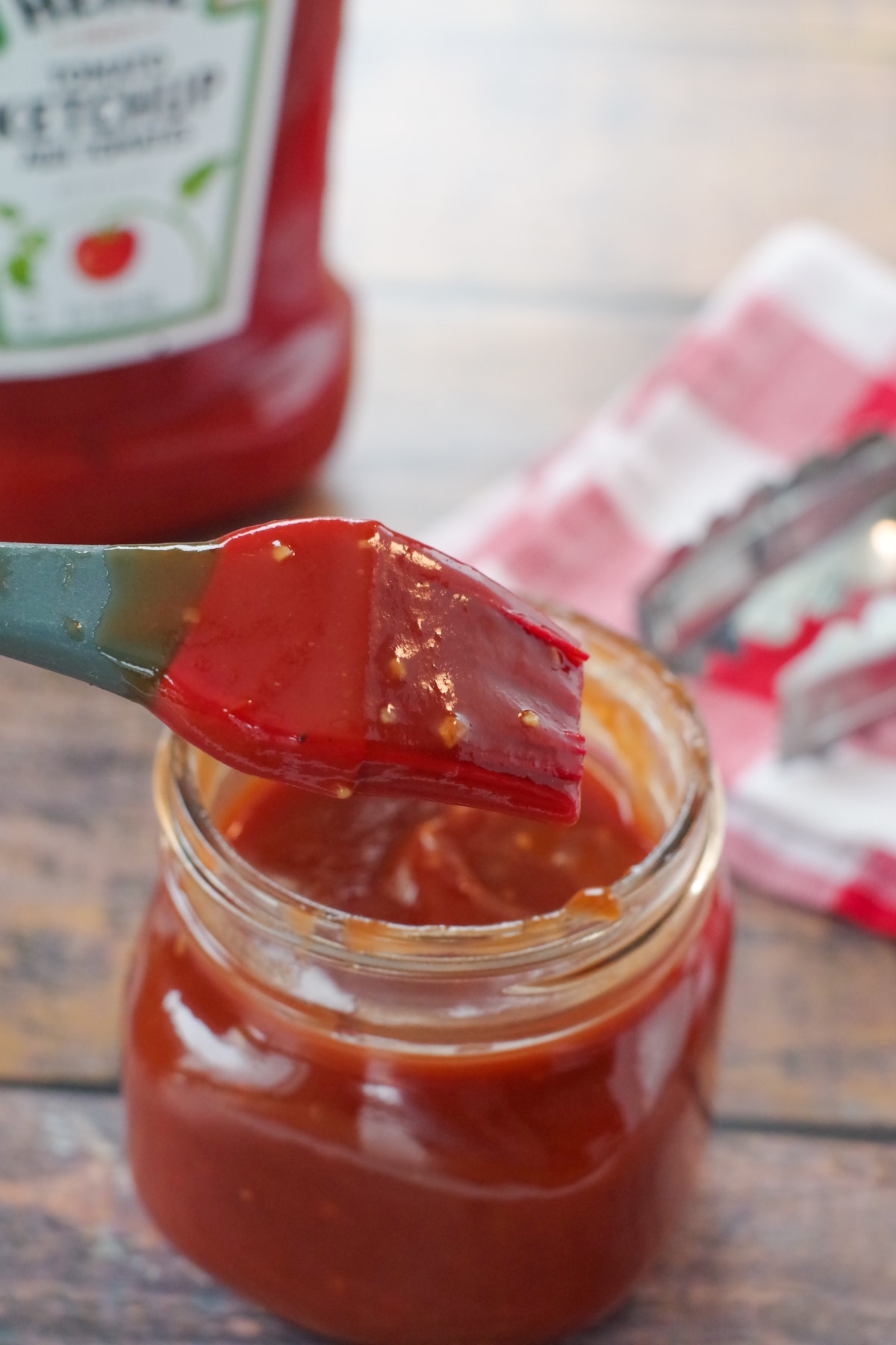 BBQ sauce with ketchup in a jar with a bottle of ketchup in the background