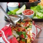 Walking Tacos in front of a tray of all of the ingredients.