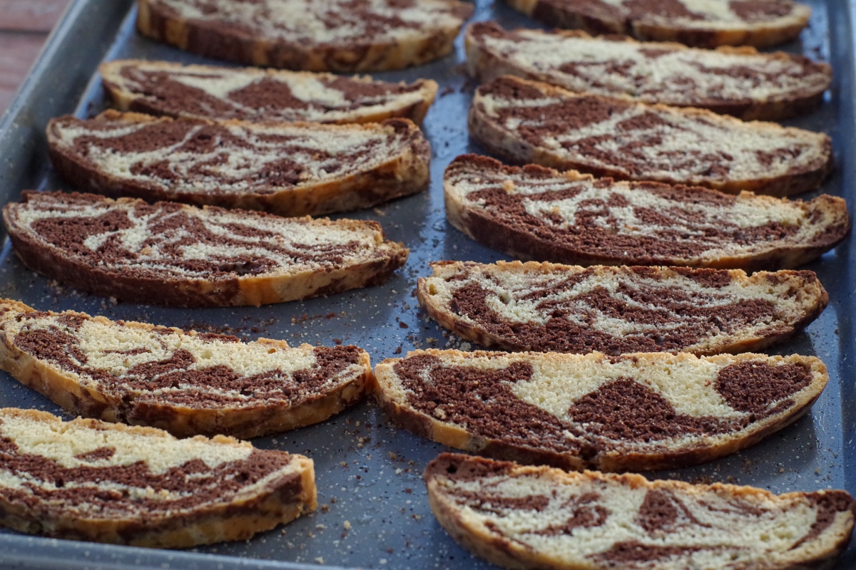 chocolate marble biscotti on a blue baking sheet