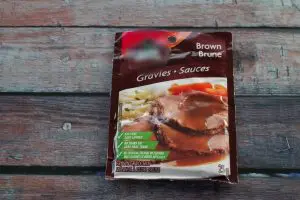 package of instant gravy on a wooden surface