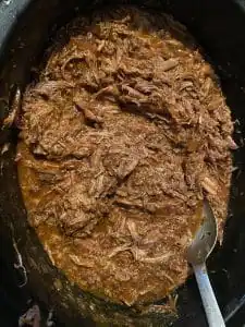 shredded beef in sauce in slow cooker