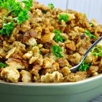 old fashioned turkey stuffing in a green dish with spoon