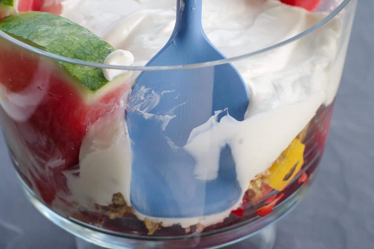 spatula pushing back trifle to make room for watermelon