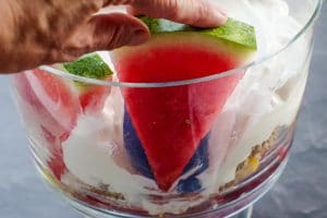 watermelon being added to trifle bowl (in front of spatula)