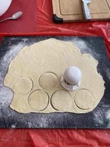 perogy dough being cut into circles
