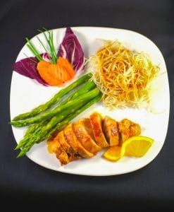 Hoisin sauce with chicken on white plate with asparagus and chow mein noodles