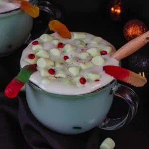 Halloween hot chocolate in a clear mug with a black background
