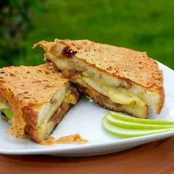 Irish apple Pie twice grilled cheese on a white plate with a green background