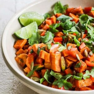 Sweet potato salad with chili lime dressing in a white bowl (with half the bowl showing)