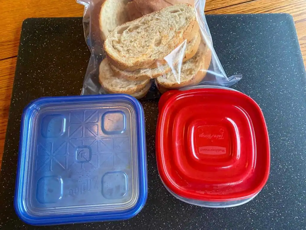 2 containers with french toast ingredients and a bag of slice French bread