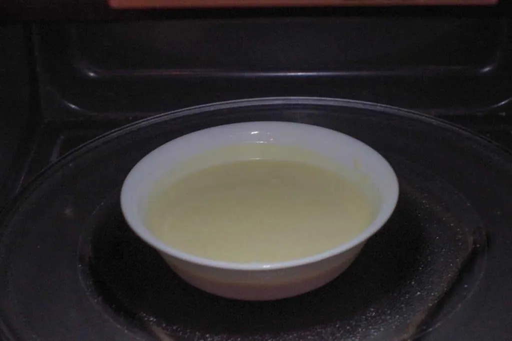 Hollandaise sauce in a white bowl in microwave
