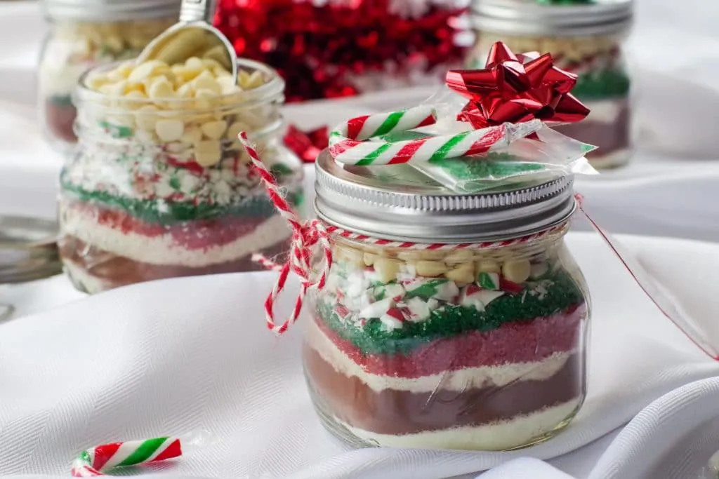 hot cocoa mix in a jar with bow, label and candy cane
