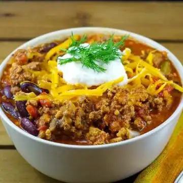 chili in a bowl on a wooden surface