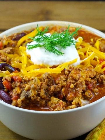 chili in a bowl on a wooden surface