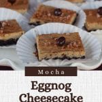 eggnog cheesecake bars on paper holders, on a white platter