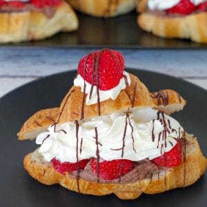 Strawberry eclair on a black plate