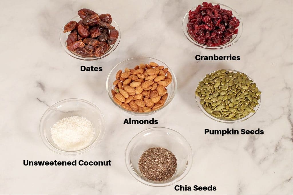 ingredients in healthy homemade energy bars, labelled, in small glass bowls