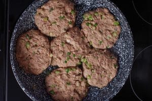 uncooked tuna burgers in a frying pan