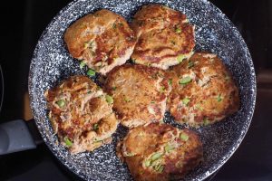 tuna burgers cooked/browned in a frying pan