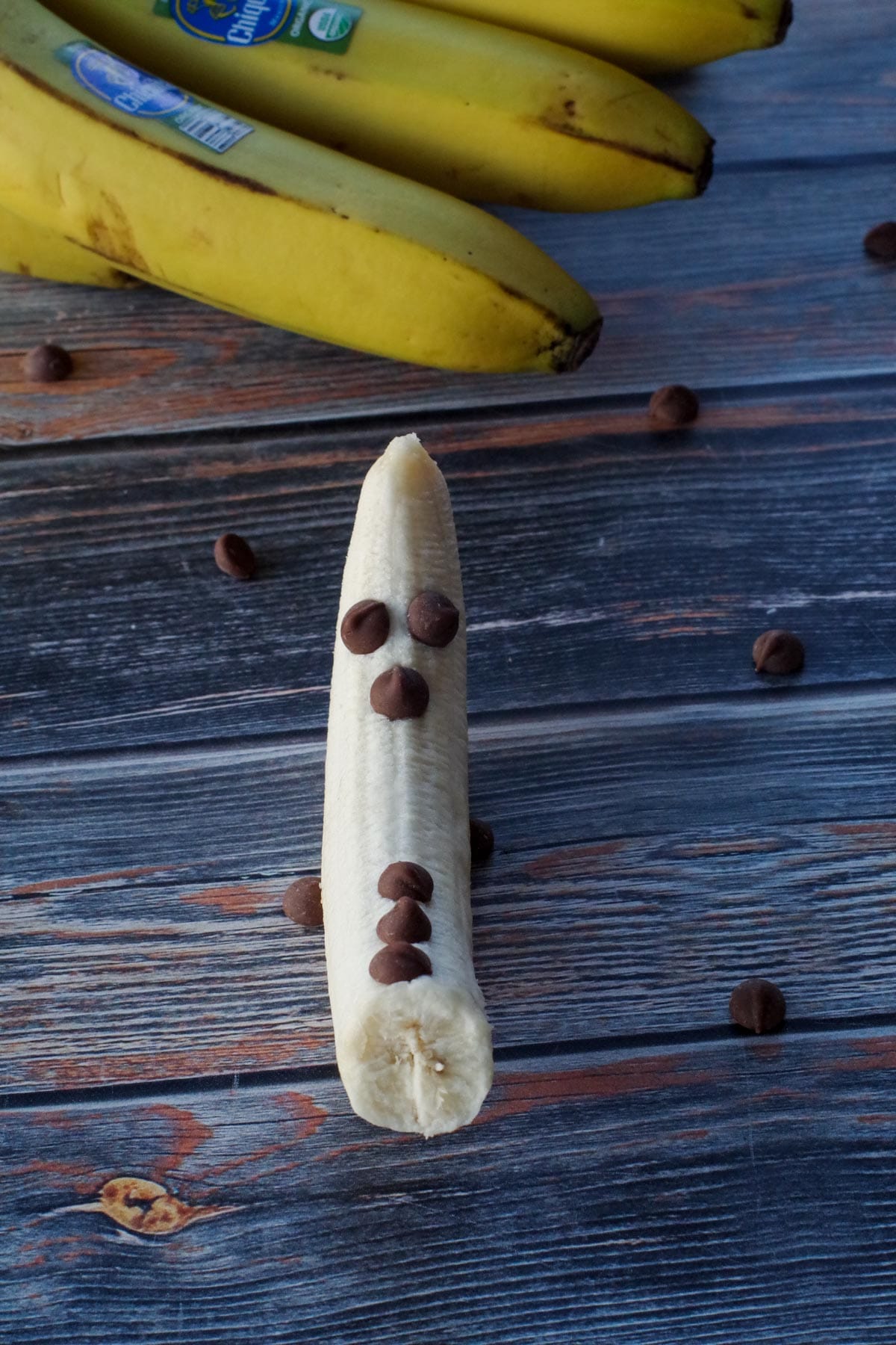 banana with chocolate chip eyes, nose and 3 chocolate chip buttons
