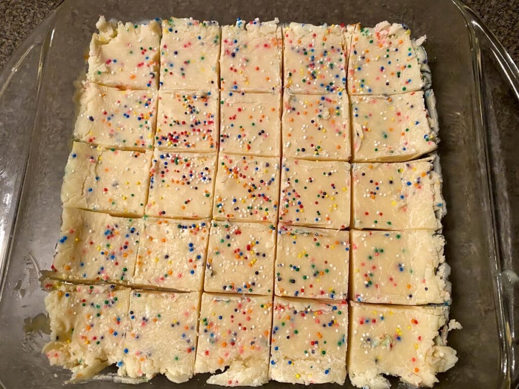 cooked sugar cookie fudge, cut into pieces, in a glass pan