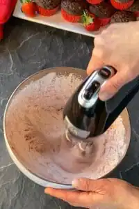 all ingredients being whipped with electric hand mixer