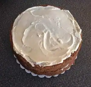 3 layer cake with frosting on top and between layers