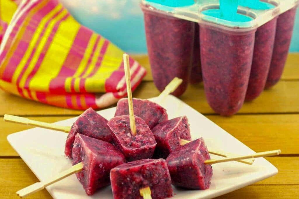 sugar-free fruit ice pops and a plate with more in popsicle moulds in the background