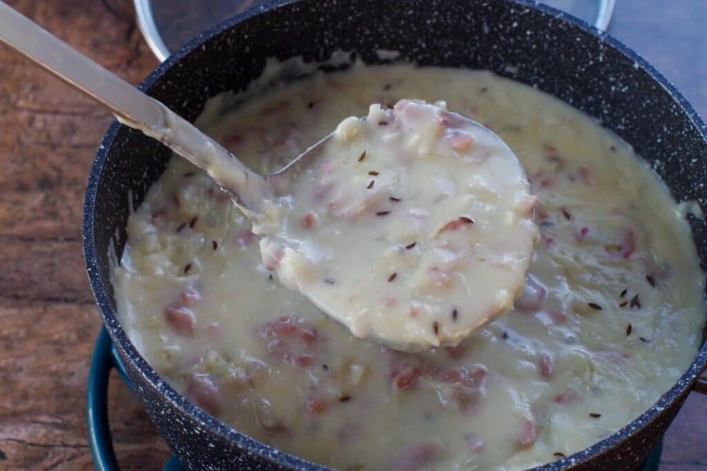 Reuben soup being scooped out with ladle