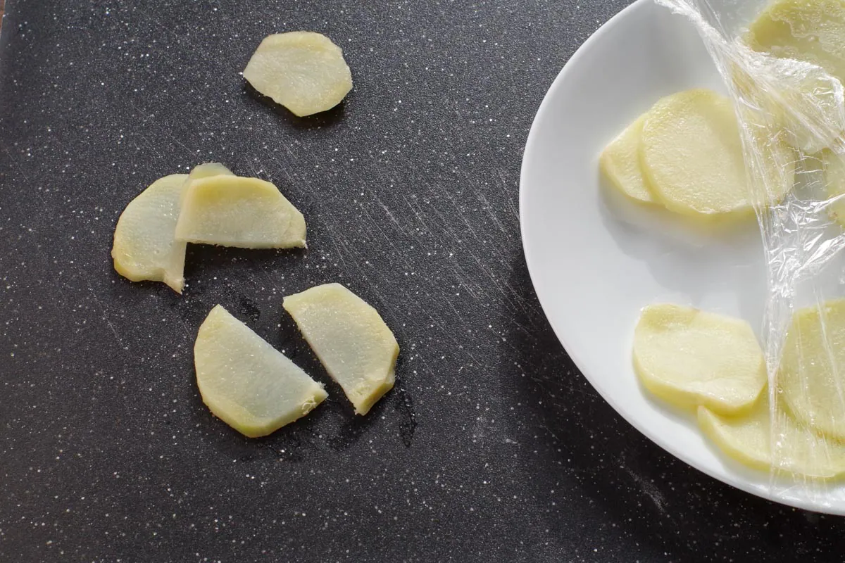 potato slices cooked and cut in half on cutting board