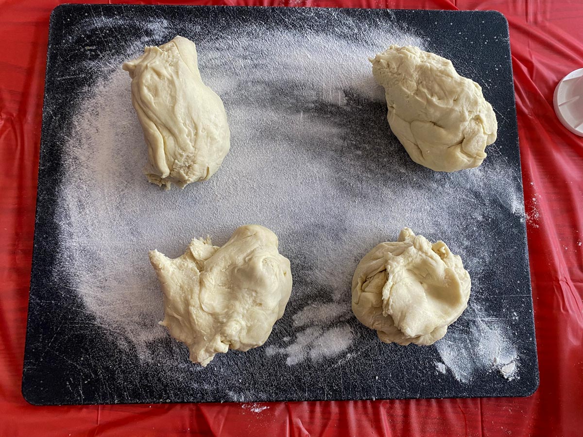 dough on cutting board, divided into 4