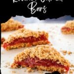 Rhubarb Oatmeal Bars cut in half (into triangles) on parchment paper.