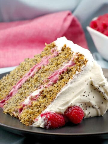 a slice of lemon poppy seed cake with raspberry filling