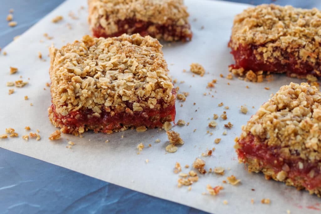 rhubarb crumble bars on a piece of parchment paper