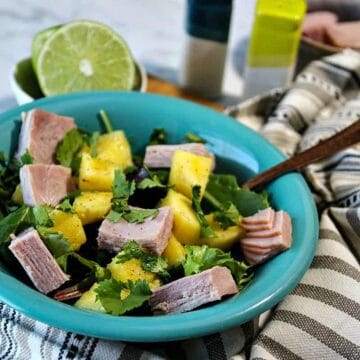 tropical salad with ham in a blue bowl