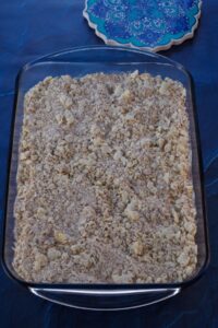Oat crumble topping put on rhubarb mixture