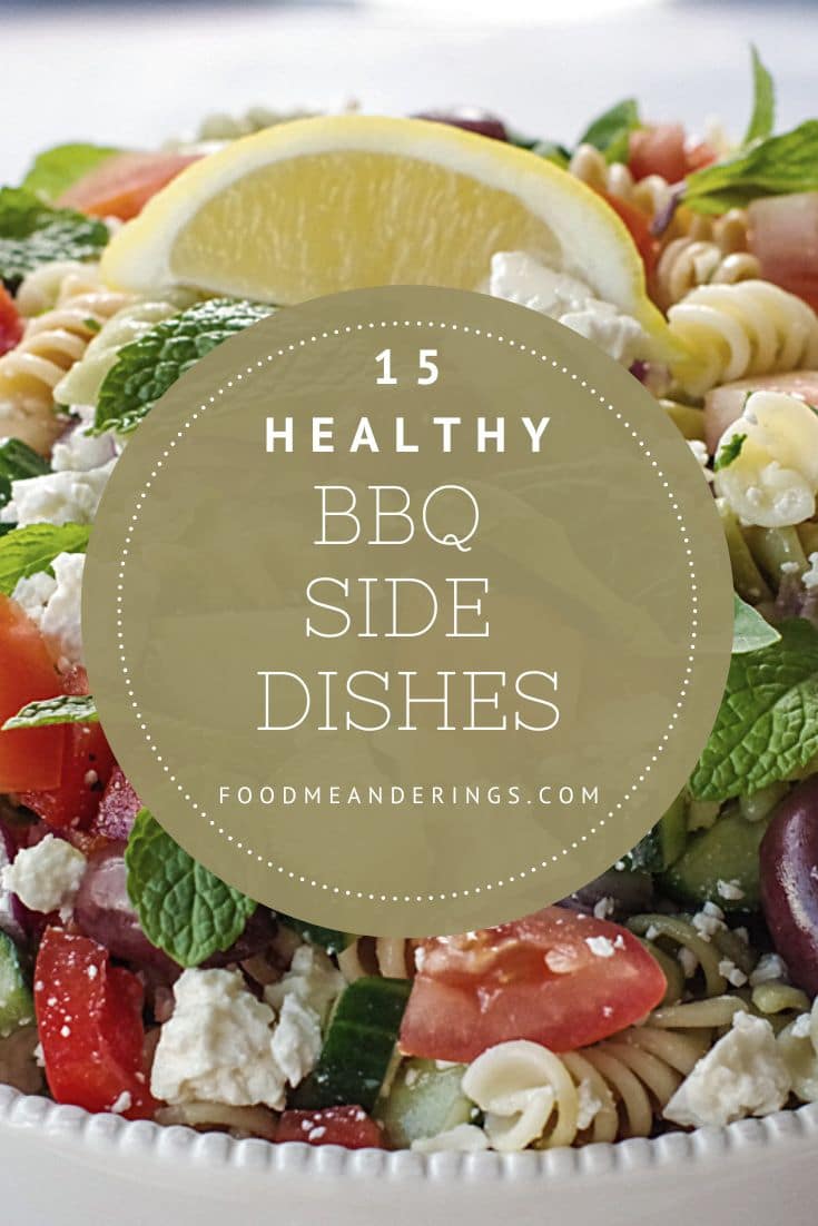 pin with Greek pasta salad in the background and light beige text on darker beige background