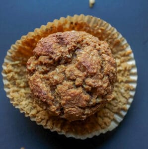 butternut squash bran muffin, with muffin wrapper peeled off, sittingon muffin wrapper